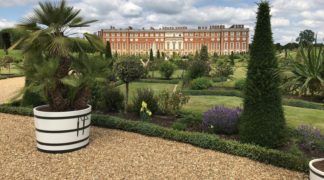 The Hampton Court Palace and it's Gardens. Golden gravel has been used to cover the ground.