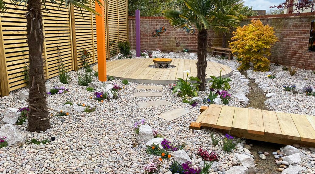 Overview of Club Tropicana garden with Scottish Pebbles and Cobbles and Longstone Rockery and water feature