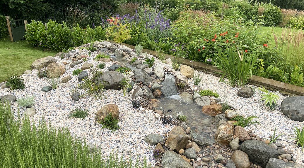 medium pondless water fall with boulders and gravel