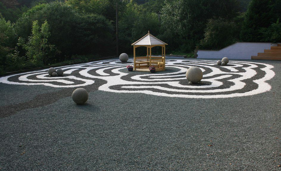 mix of black and white gravel in circular patterns to create a labyrinth