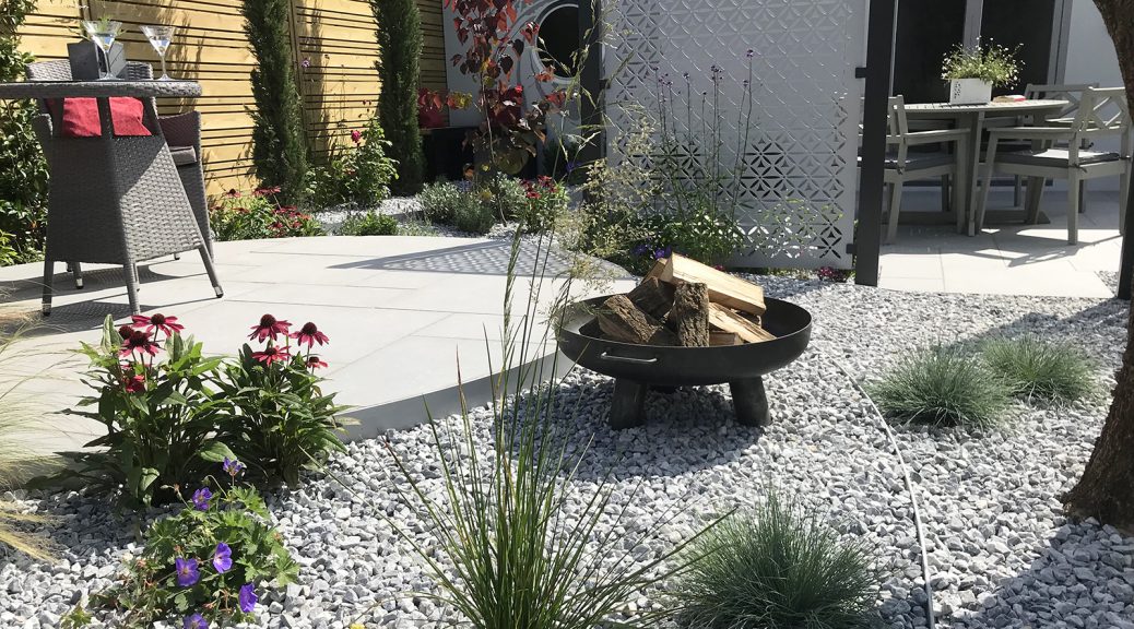 Ice Blue Chippings combined with grey paving in a flower show garden